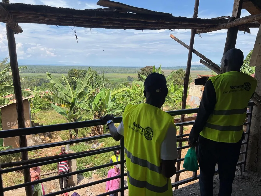 Two Rotary Club of Konge Lukuli members looking out over the landscape from the first floor of the clinic