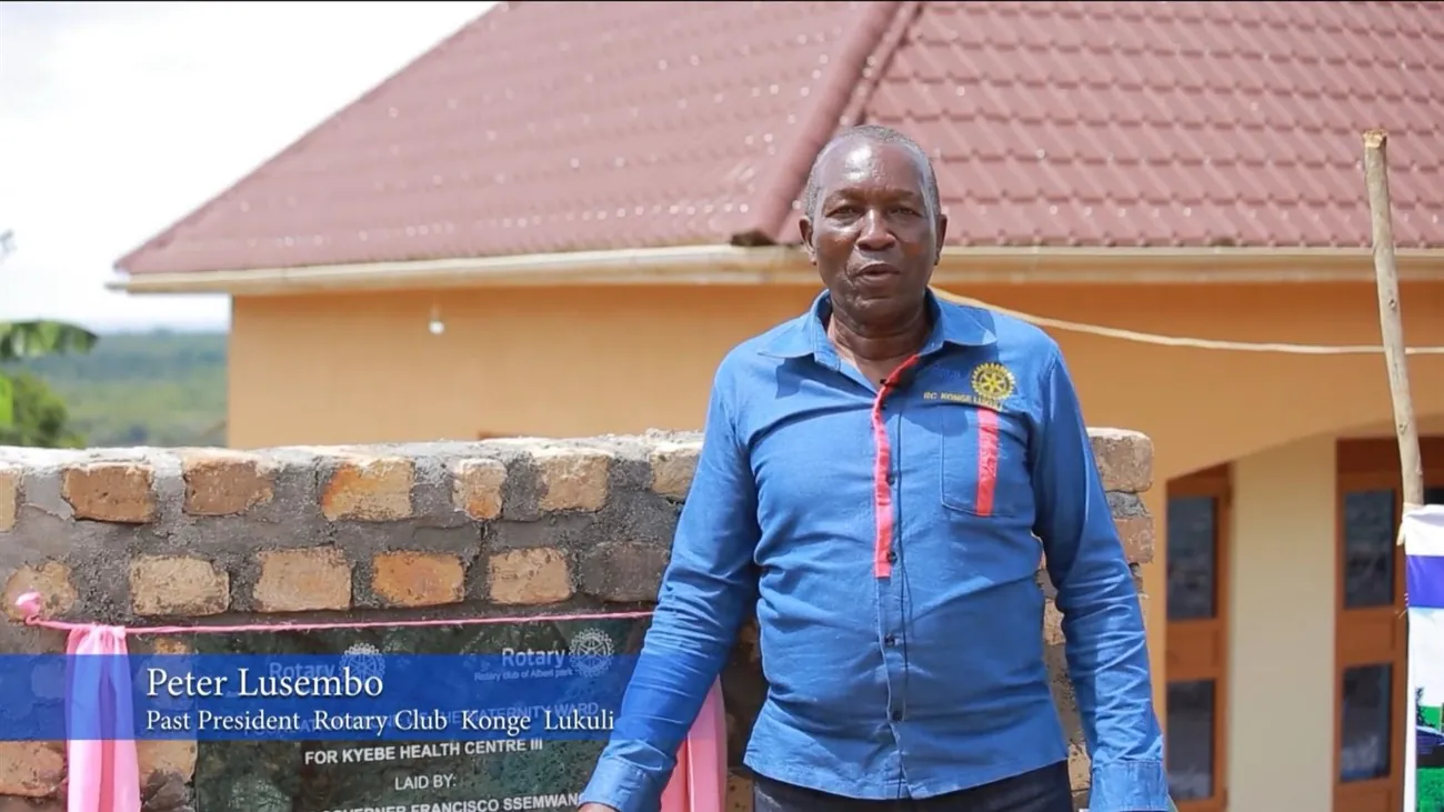 Peter Lusembo outside the completed maternity ward at Kyebe Health Centre III